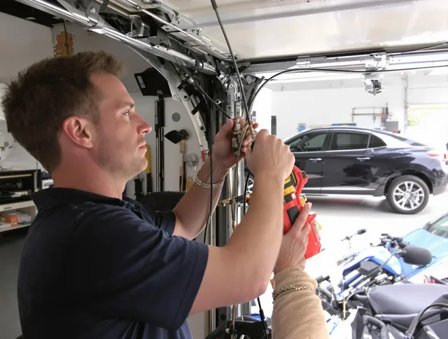 Ledyard Garage Door Repair safety certified technician performing cable replacement in Ledyard