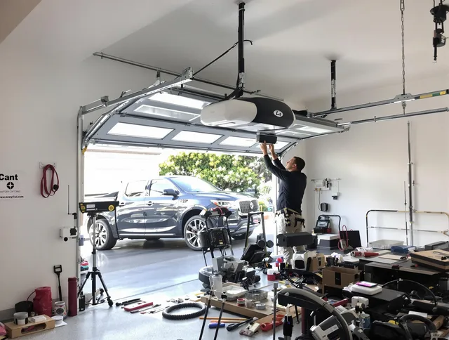 Ledyard Garage Door Repair specialist installing smart garage door opener system in Ledyard home