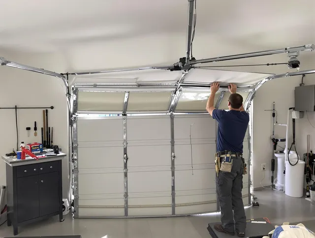 Ledyard Garage Door Repair specialist performing precise section replacement on Ledyard garage door